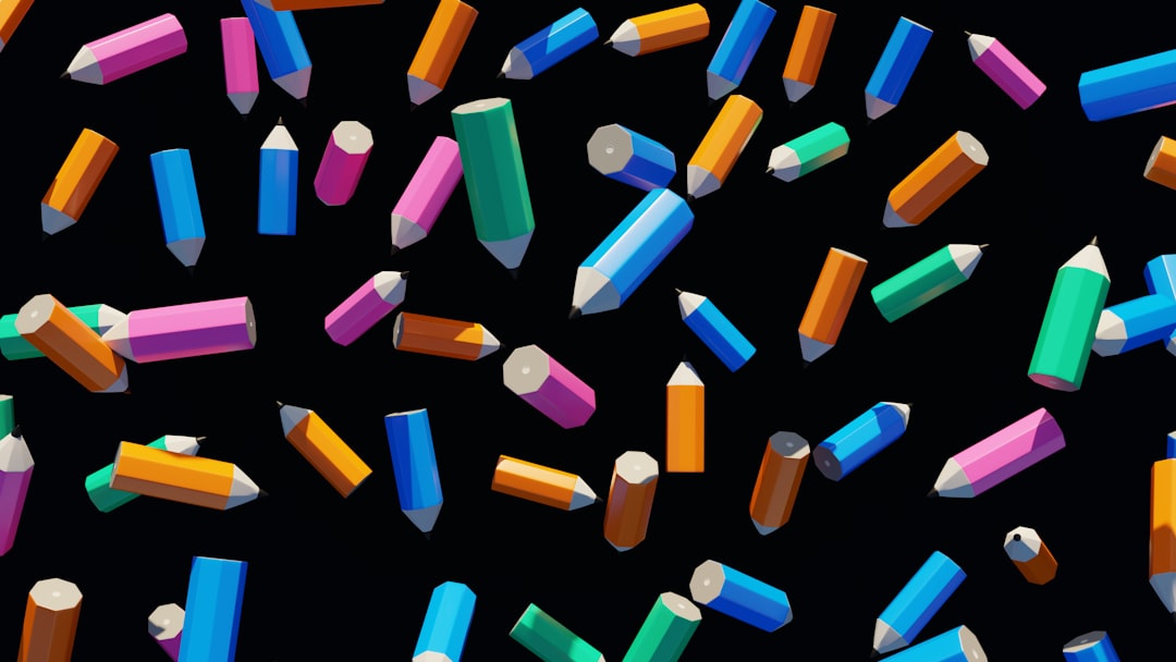 Colorful pencils falling against a black background.