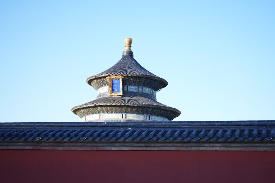 The Temple of Heaven in Beijing features intricate architecture against a bright blue sky.
