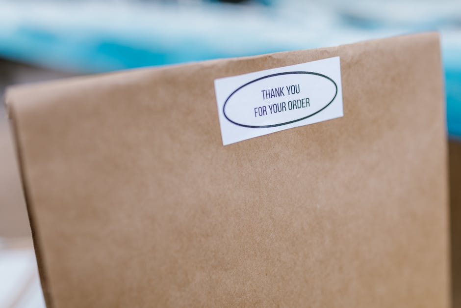 Close-up of a brown paper bag with a thank you sticker for delivery service.